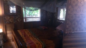 Bed in Kavieng with mosquito net above it. To sleep, you need to tuck the mosquito net under the mattress to keep any mosquitoes from biting you while sleeping. It worked well! (Photo by Gregory Jeff Barord)